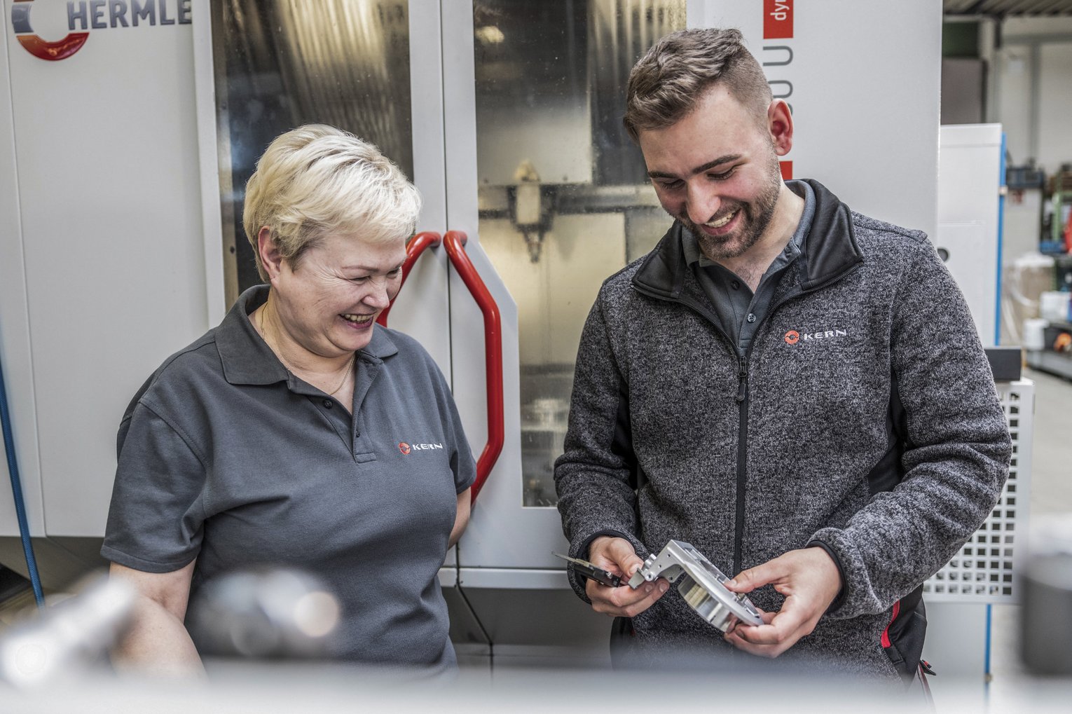 Two employees chat in the production facility at Kern Motion Technology