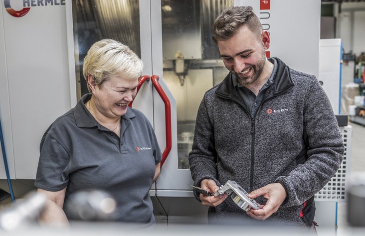 Two employees chat in the production facility at Kern Motion Technology