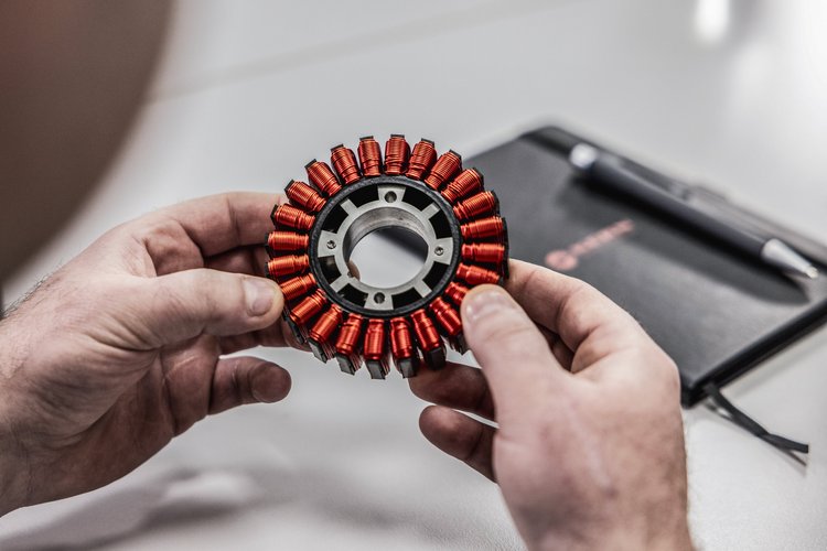 Men’s hands holding a coil