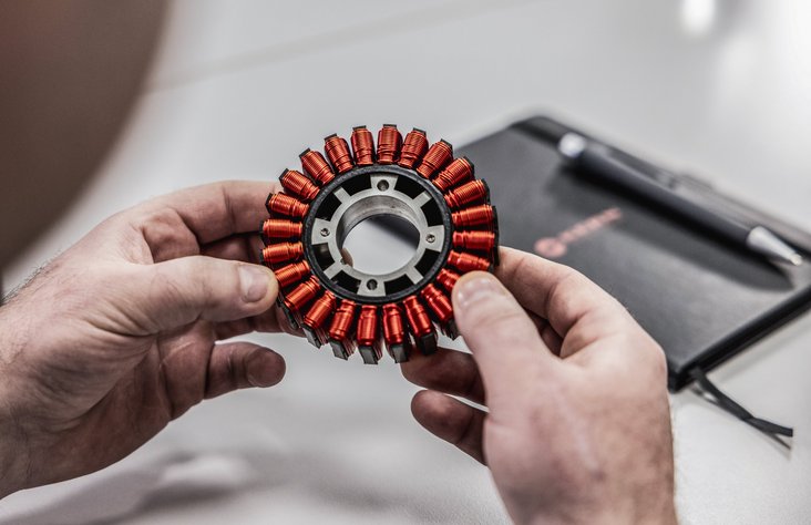 Men’s hands holding coils